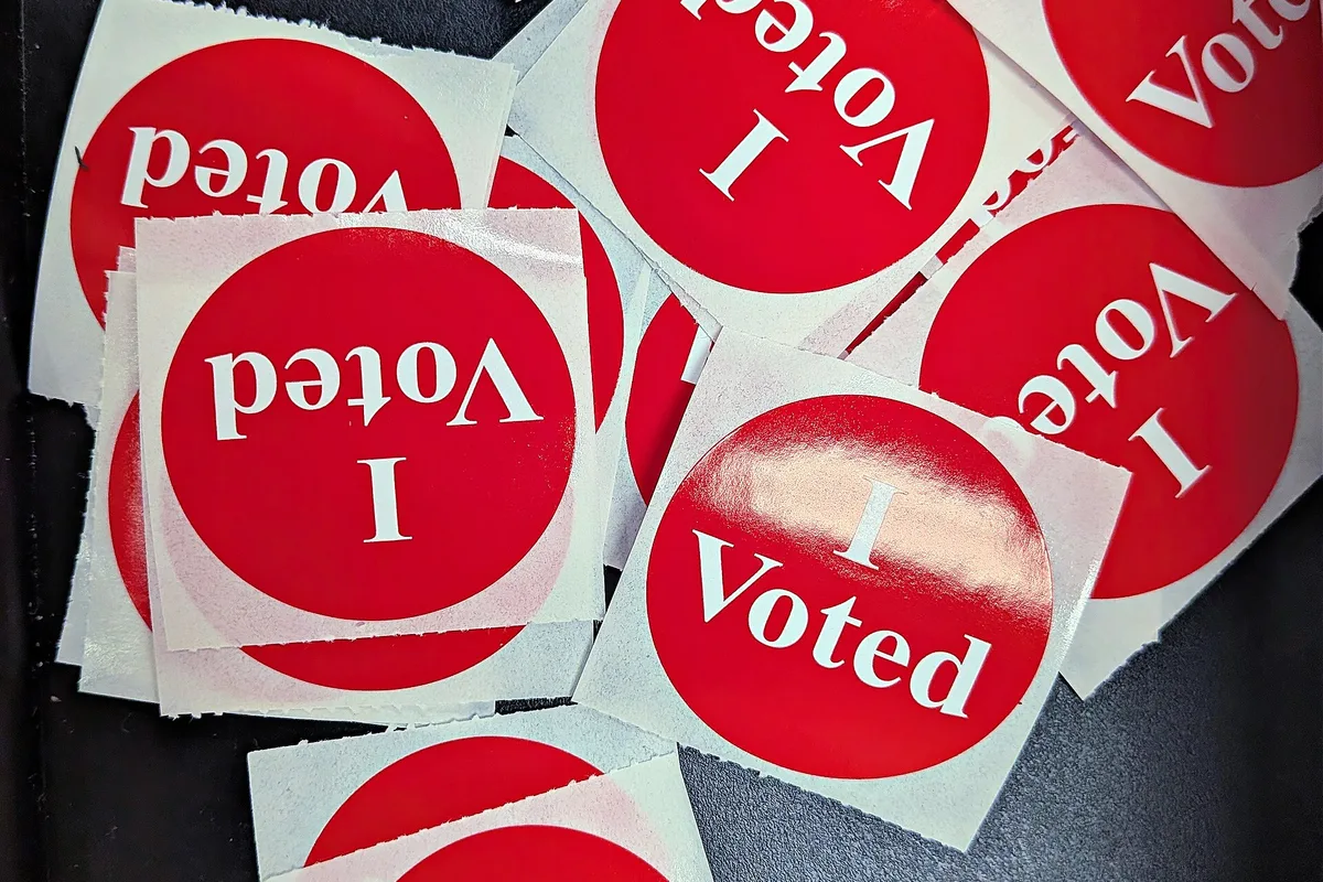 A pile of round red "I Voted" stickers