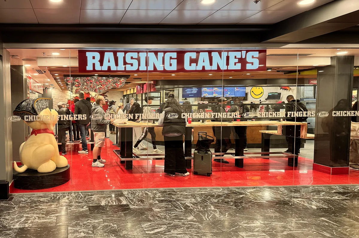 Red Raising Cane's sign above the counter of a Raising Cane's restaurant in Washington, D.C.